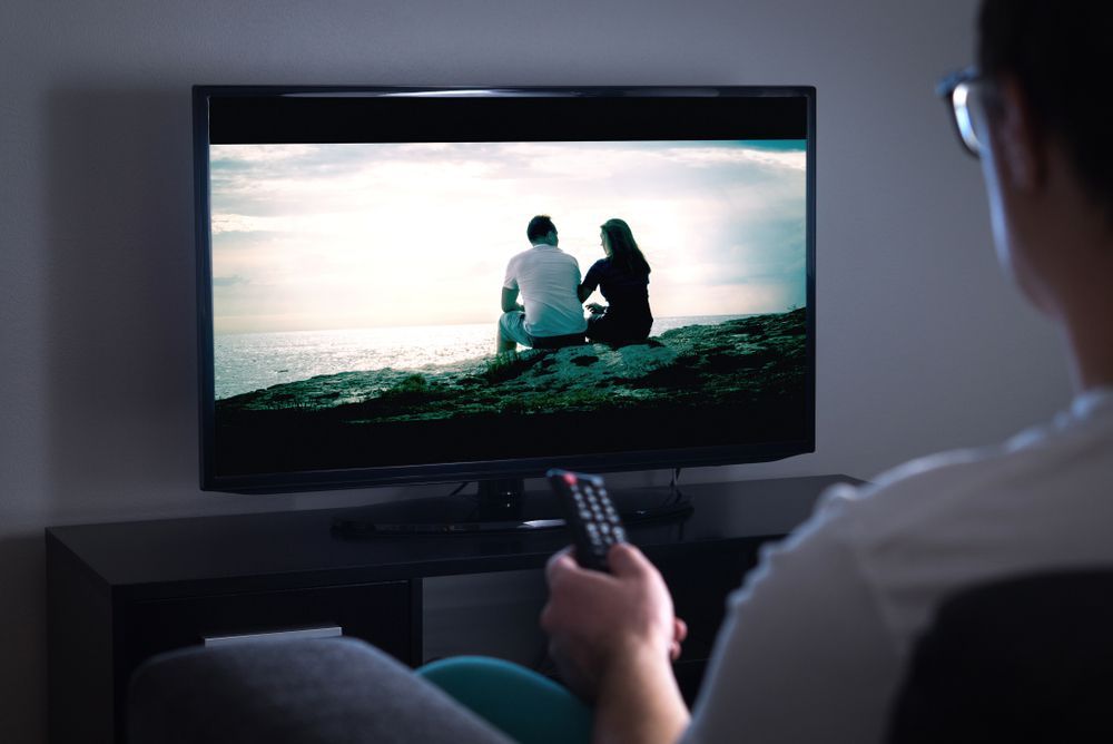 Person Watching a TV Scene of Two People — MATV Systems Australia Pty Ltd in Wickham, NSW