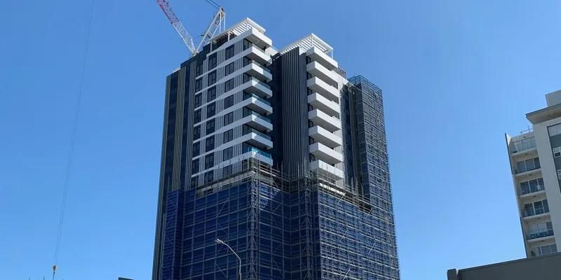 A Tall Building Under Construction, Covered in Blue Netting — MATV Systems Australia Pty Ltd in Wickham, NSW
