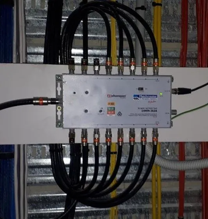 Electrical Distribution Box With Multiple Black Cables Connected in a Utility Panel Room — MATV Systems Australia Pty Ltd in Wickham, NSW
