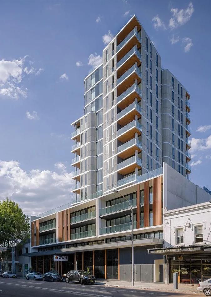 A Tall Building with A Lot of Windows Is Sitting on The Side of A Street — MATV Systems Australia Pty Ltd in Wickham, NSW