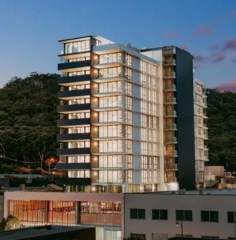 A Tall Building with Lots of Windows Is Lit up At Night — MATV Systems Australia Pty Ltd in Wickham, NSW