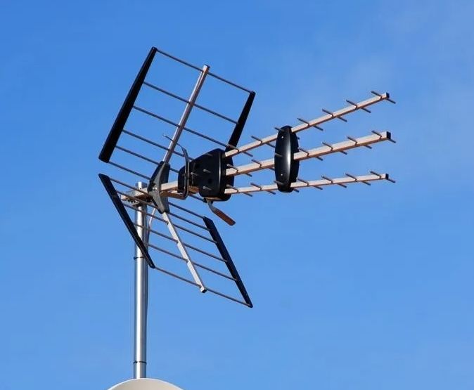 Yagi TV antenna on a rooftop pole against a clear blue sky — MATV Systems Australia Pty Ltd in Sydney, NSW