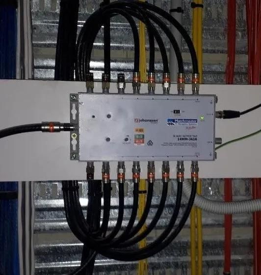 Electrical Junction Box With Multiple Black Cables Mounted on a Wall — MATV Systems Australia Pty Ltd in Wickham, NSW