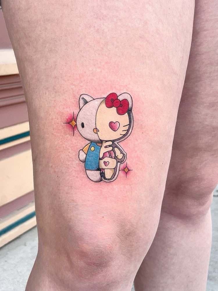 Hello Kitty tattoo split down the middle with glittery stars.