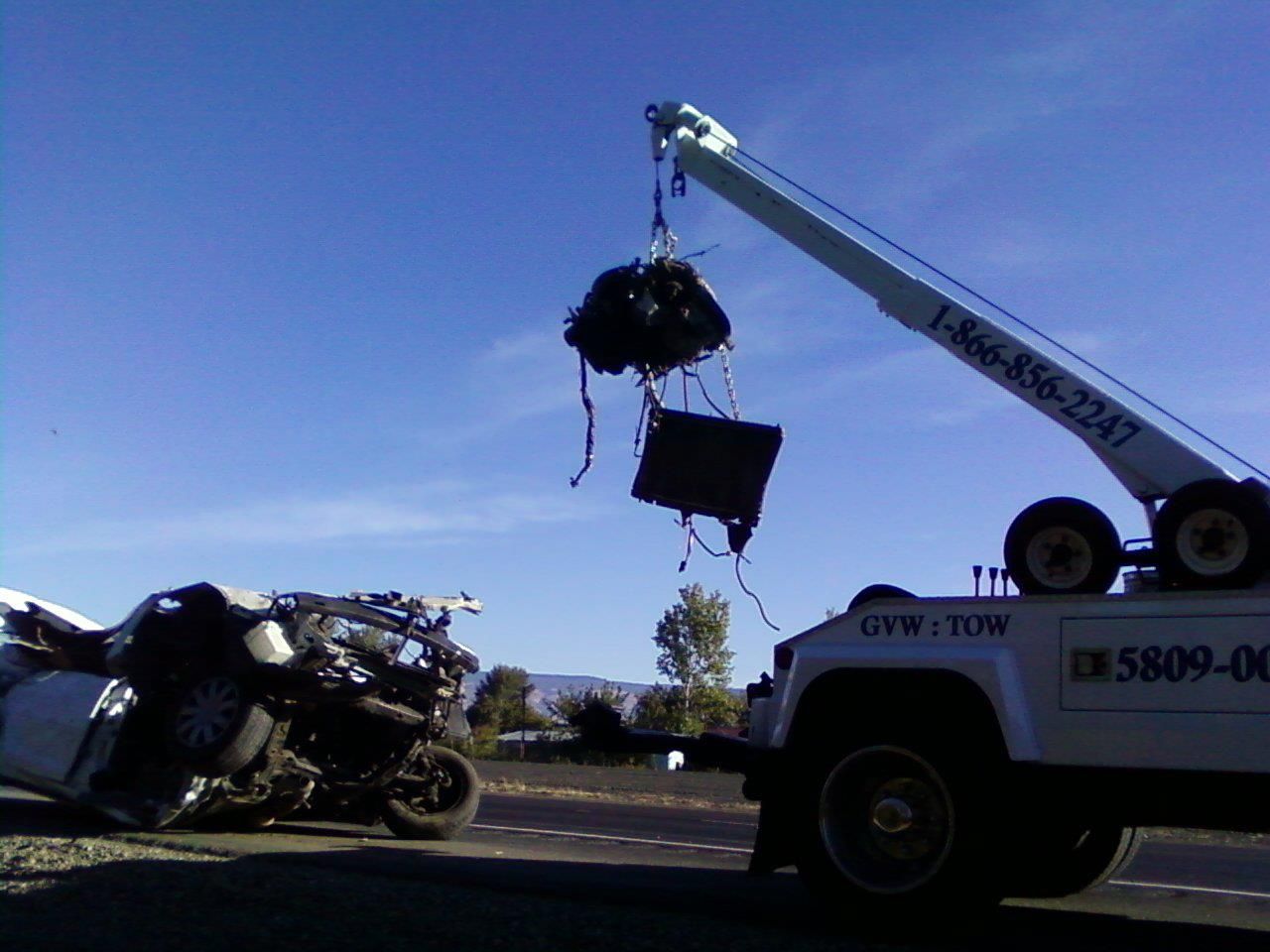 A tow truck with a crane attached to it
