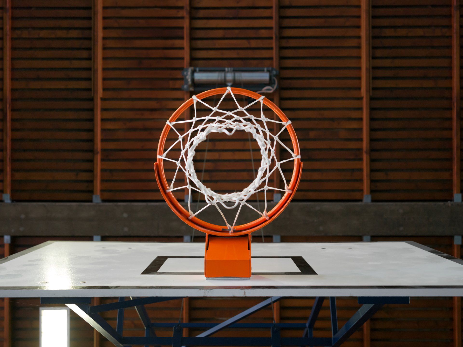 A basketball hoop is sitting on top of a basketball court.