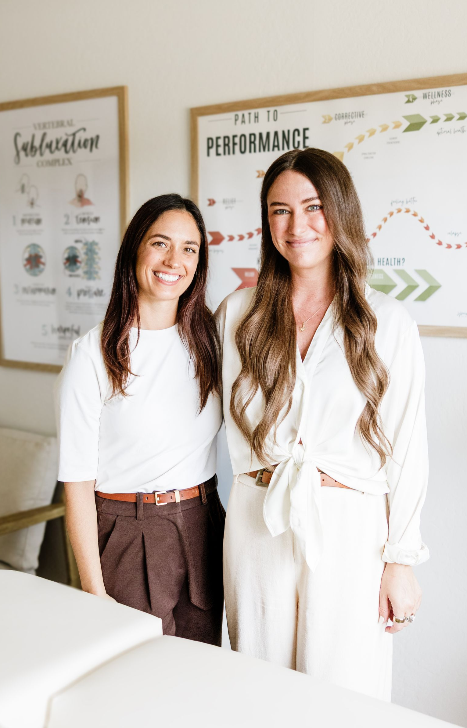 Dr. Julie Soloduka & Dr. Chloé Jones smiling in a office with lots of light.