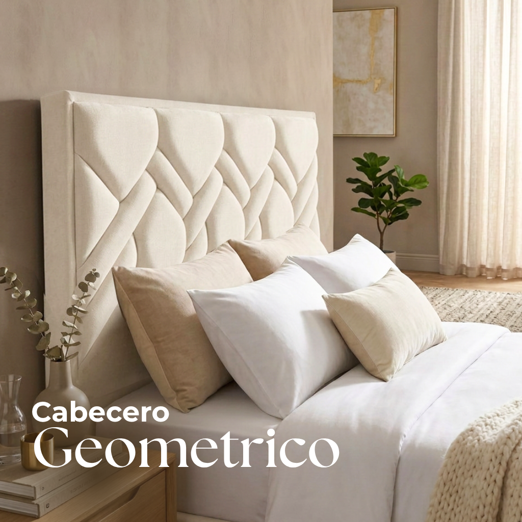 Cabecero tapizado en gris con costuras geométricas sobre una cama con almohadas blancas.