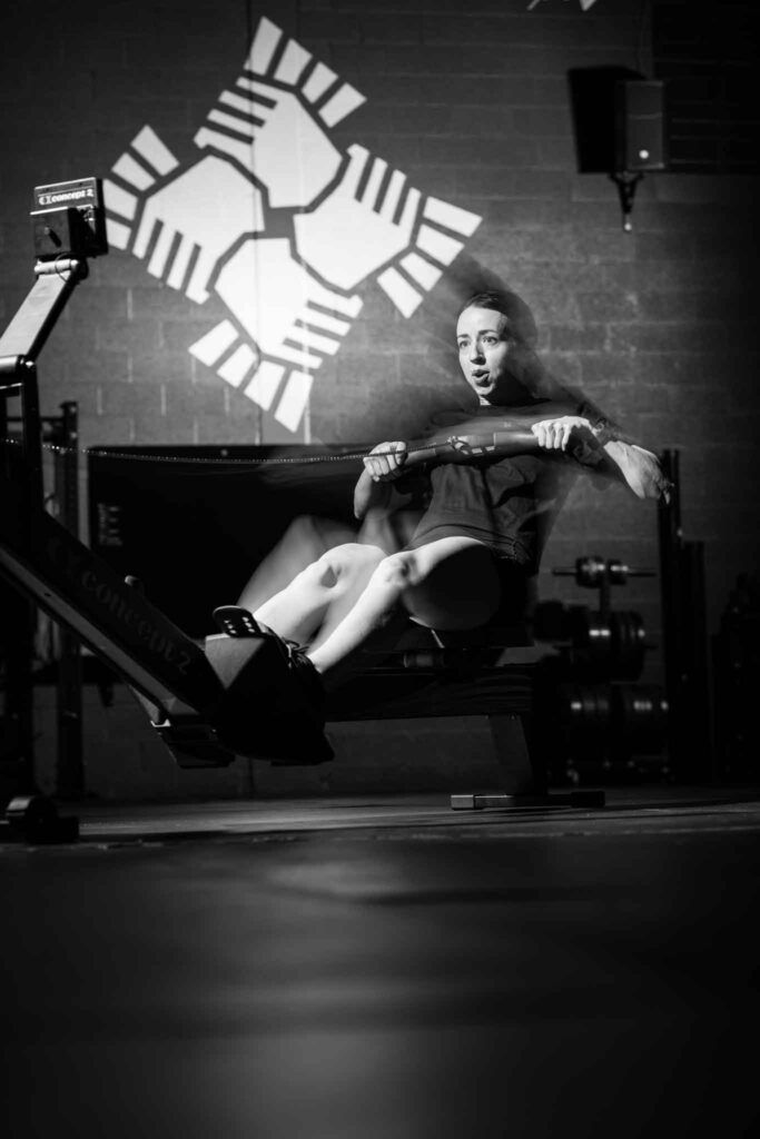 Black-and-white photo of a person working out on a rowing machine at a south salt lake gym