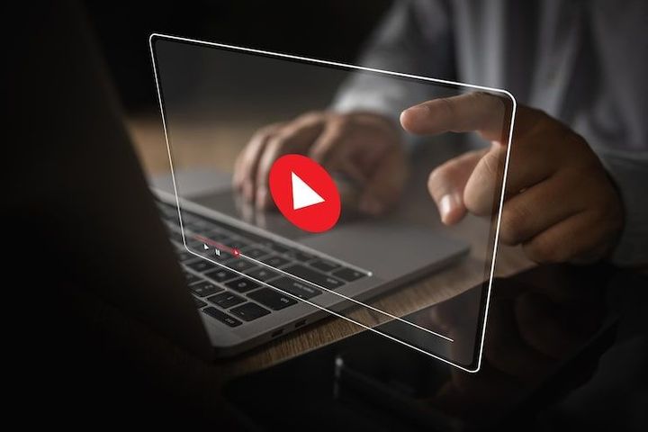 Close-up of a browser displaying the YouTube homepage logo and menu icon.
