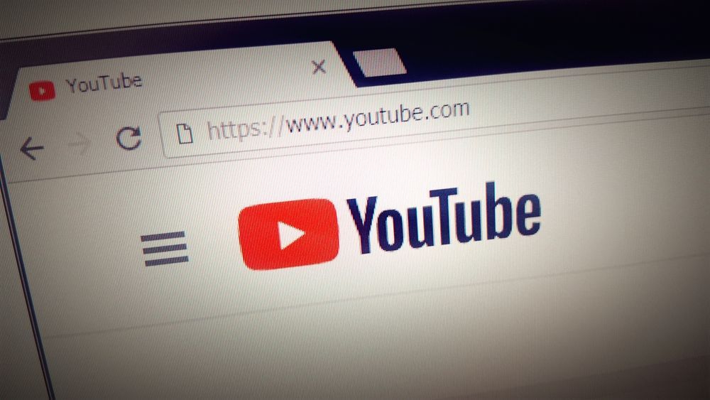 Close-up of a browser displaying the YouTube homepage logo and menu icon.