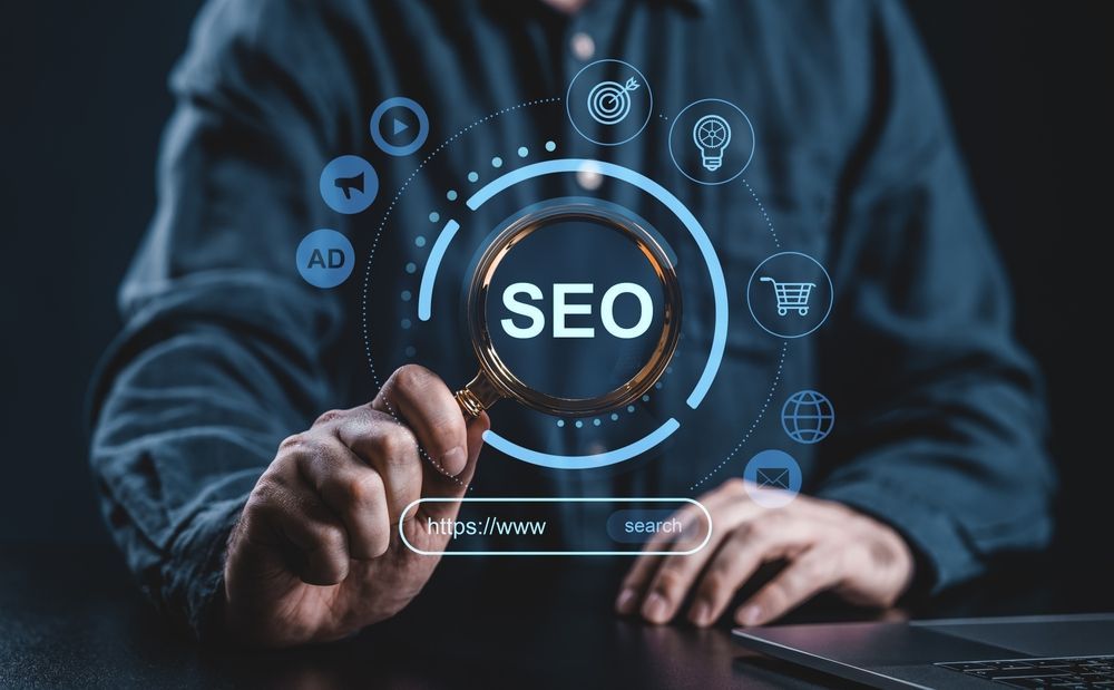 Person typing on laptop with glowing SEO interface and digital icons