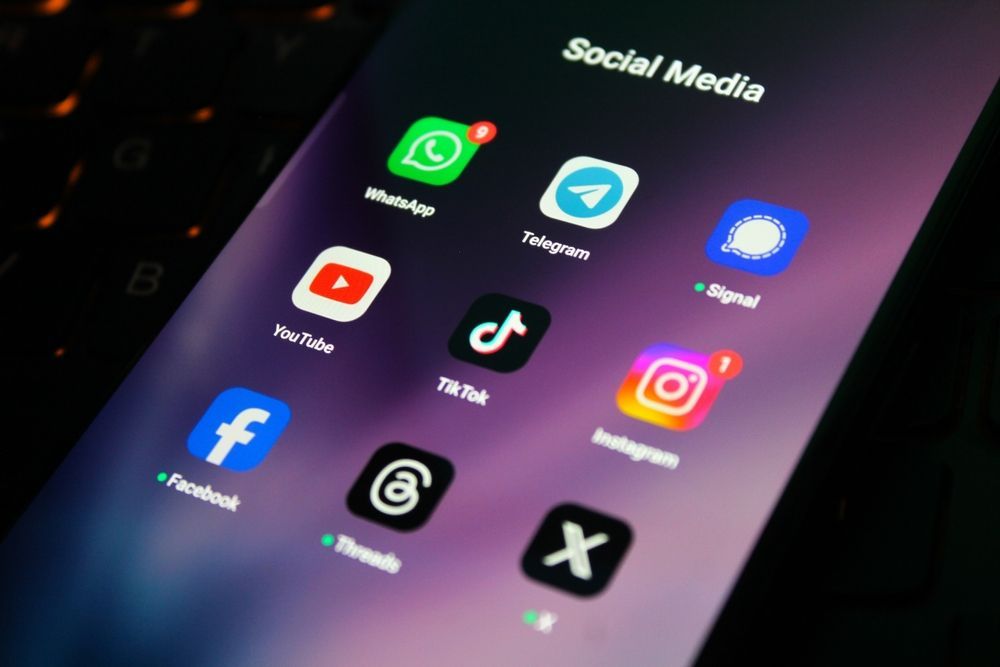Smartphone screen showing social media app icons on a dark purple background