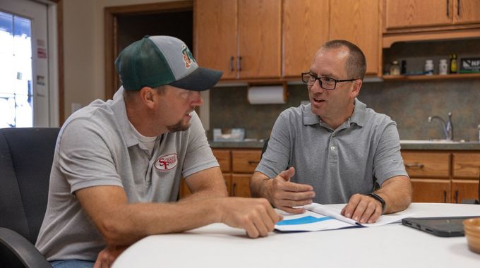 Brad Rocke doing crop consulting with farmer