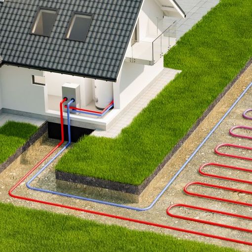 House with underground utility lines and red/blue pipes beside a grassy lawn and driveway trench
