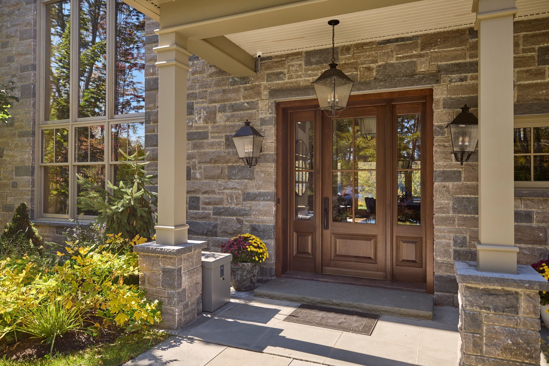 A large stone house with a porch and a wooden door