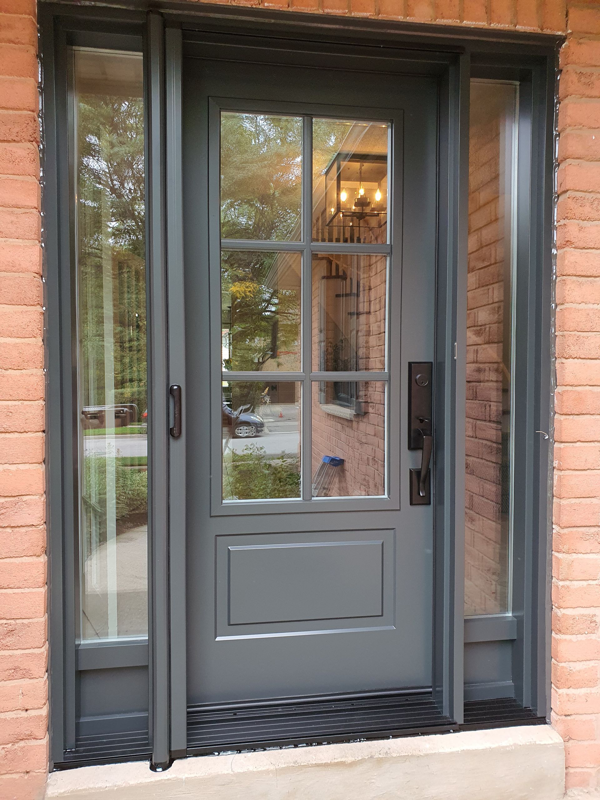 A brick building with a gray door and windows