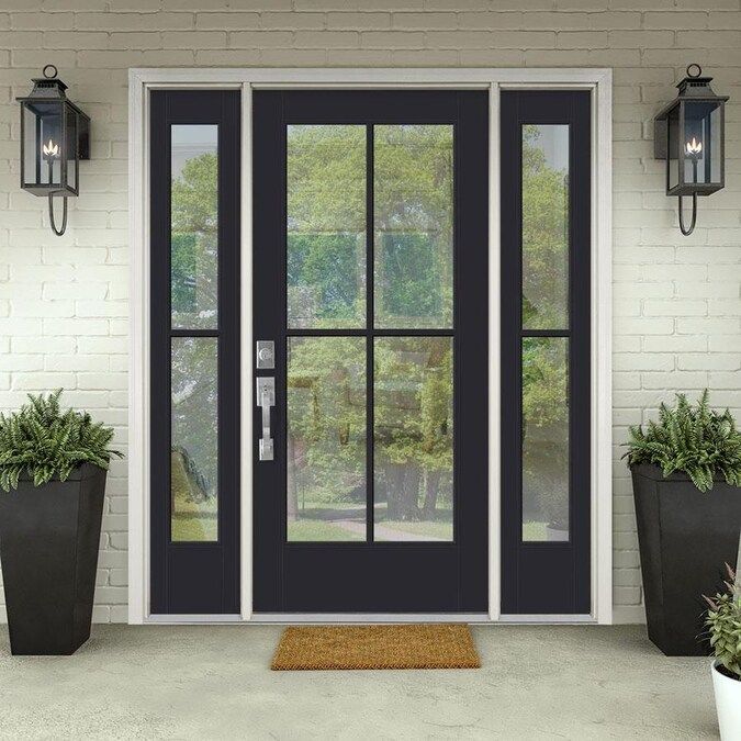 A black door with a lot of windows is on a porch.