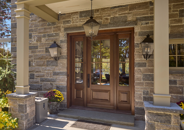 The front door of a stone house with a wooden door