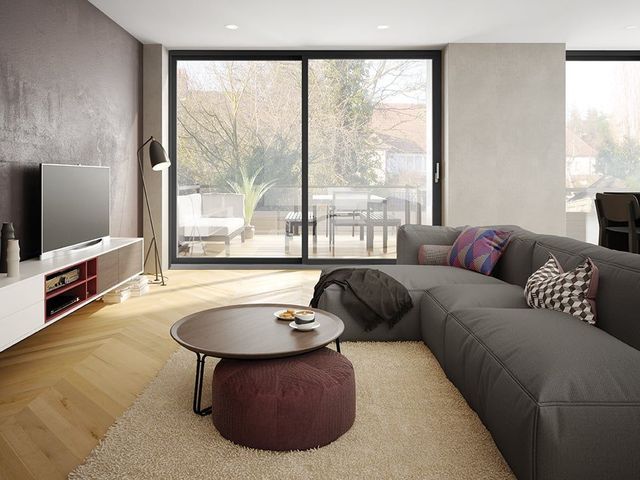 A living room with a couch , coffee table , and television.