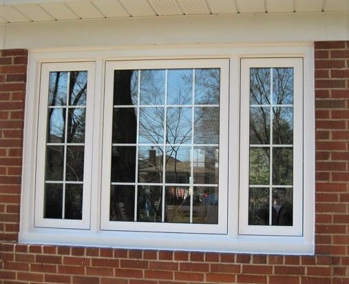 A brick building with three windows on it