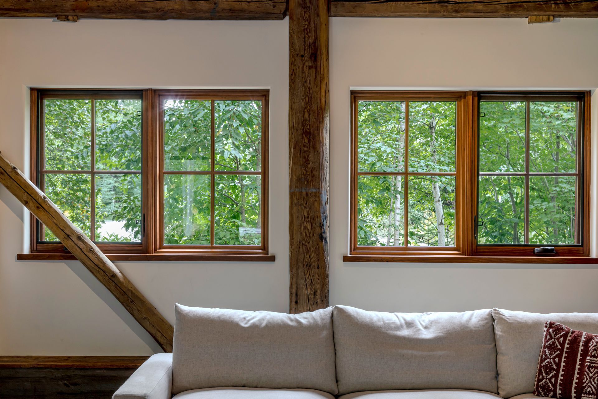 A living room with a couch and lots of windows
