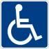 Un panneau bleu avec un symbole de fauteuil roulant blanc dessus.