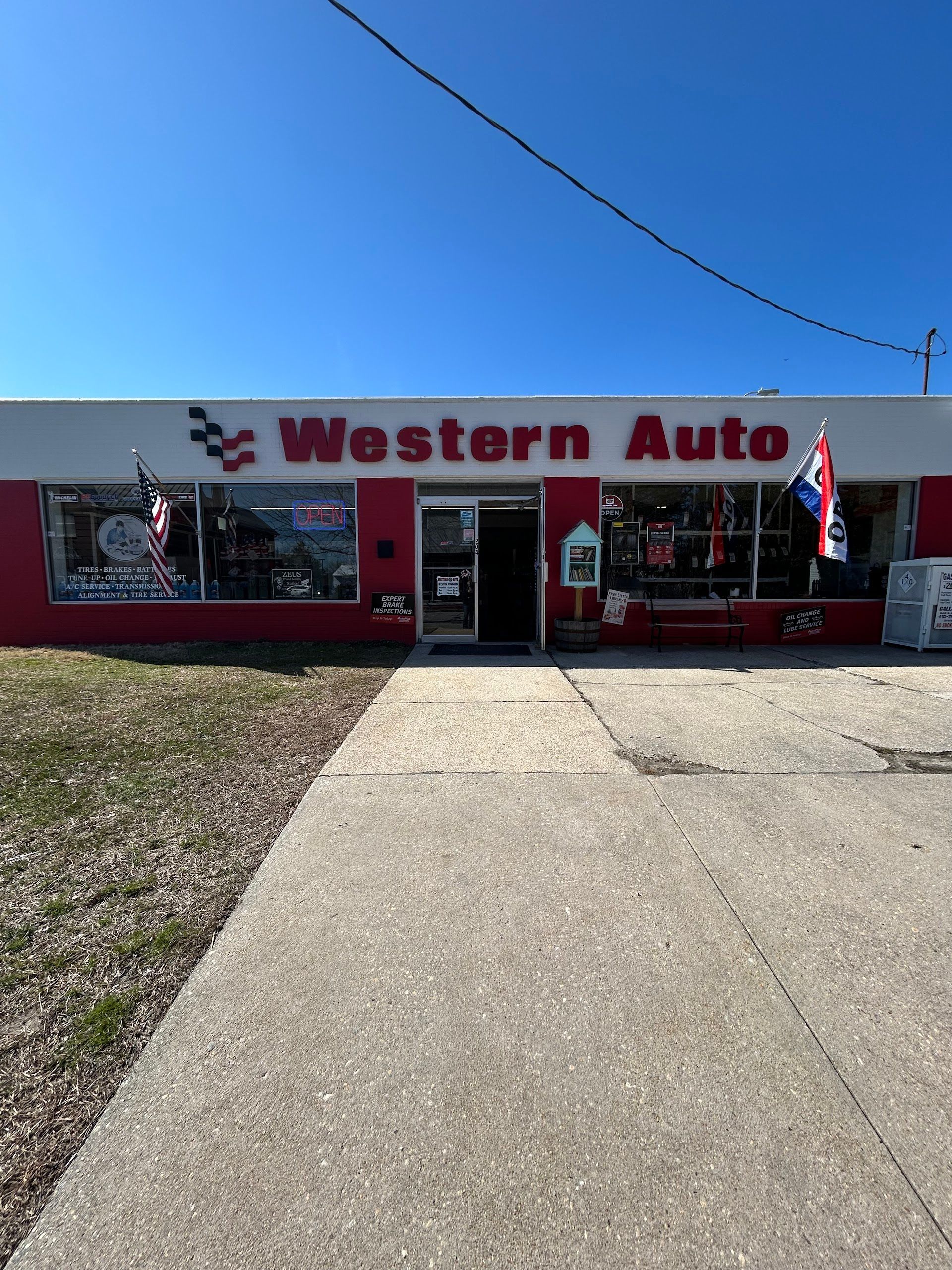 Western Auto store with red and white facade, blue sky | Western Tire & Auto of Centreville
