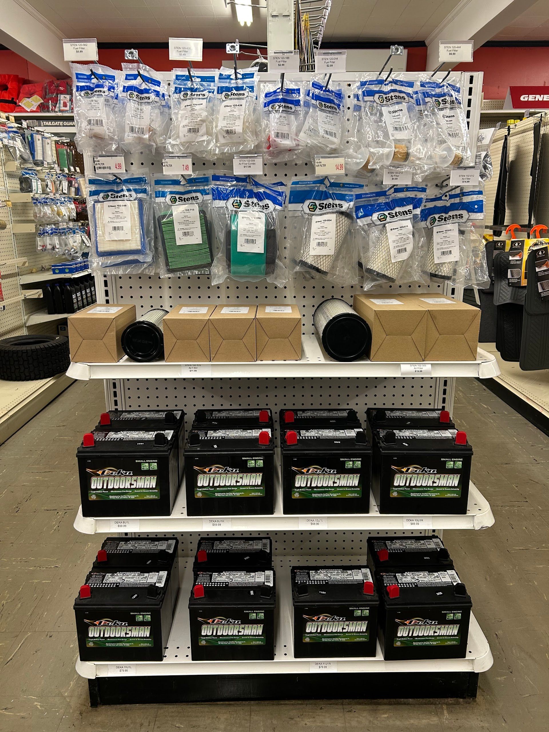 Shelves stocked with batteries and packaged hardware in a store | Western Tire & Auto of Centreville