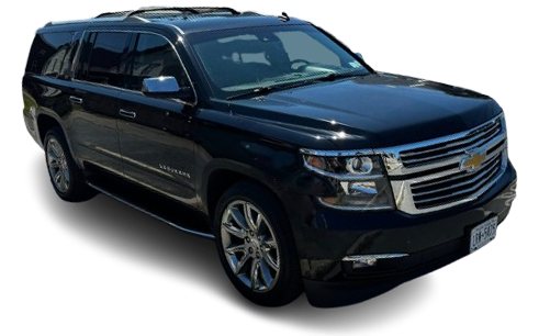A black Chevrolet Suburban SUV parked at a slight angle against a white background.