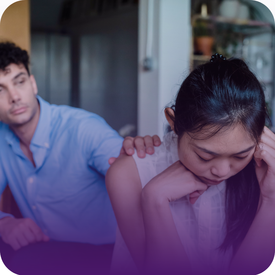 Man comforts woman with hand on her shoulder; both appear distressed.