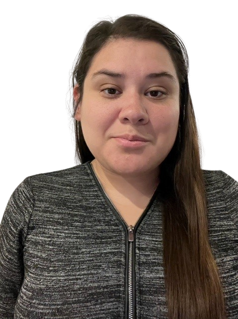 Woman with long dark hair, wearing a gray zip-up shirt, looking at the camera.