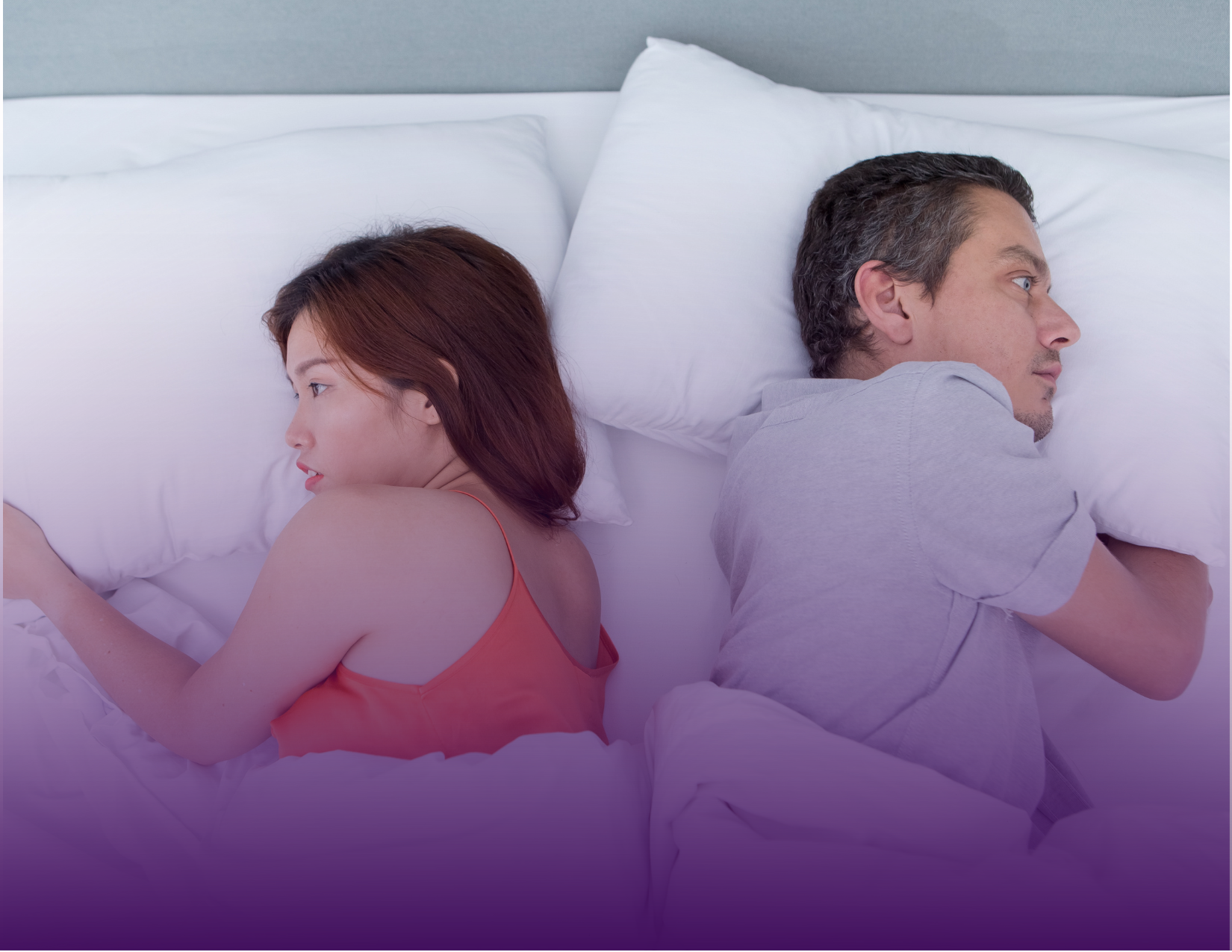 Couple lying in bed, facing away from each other; expressing sadness, tension, or conflict.