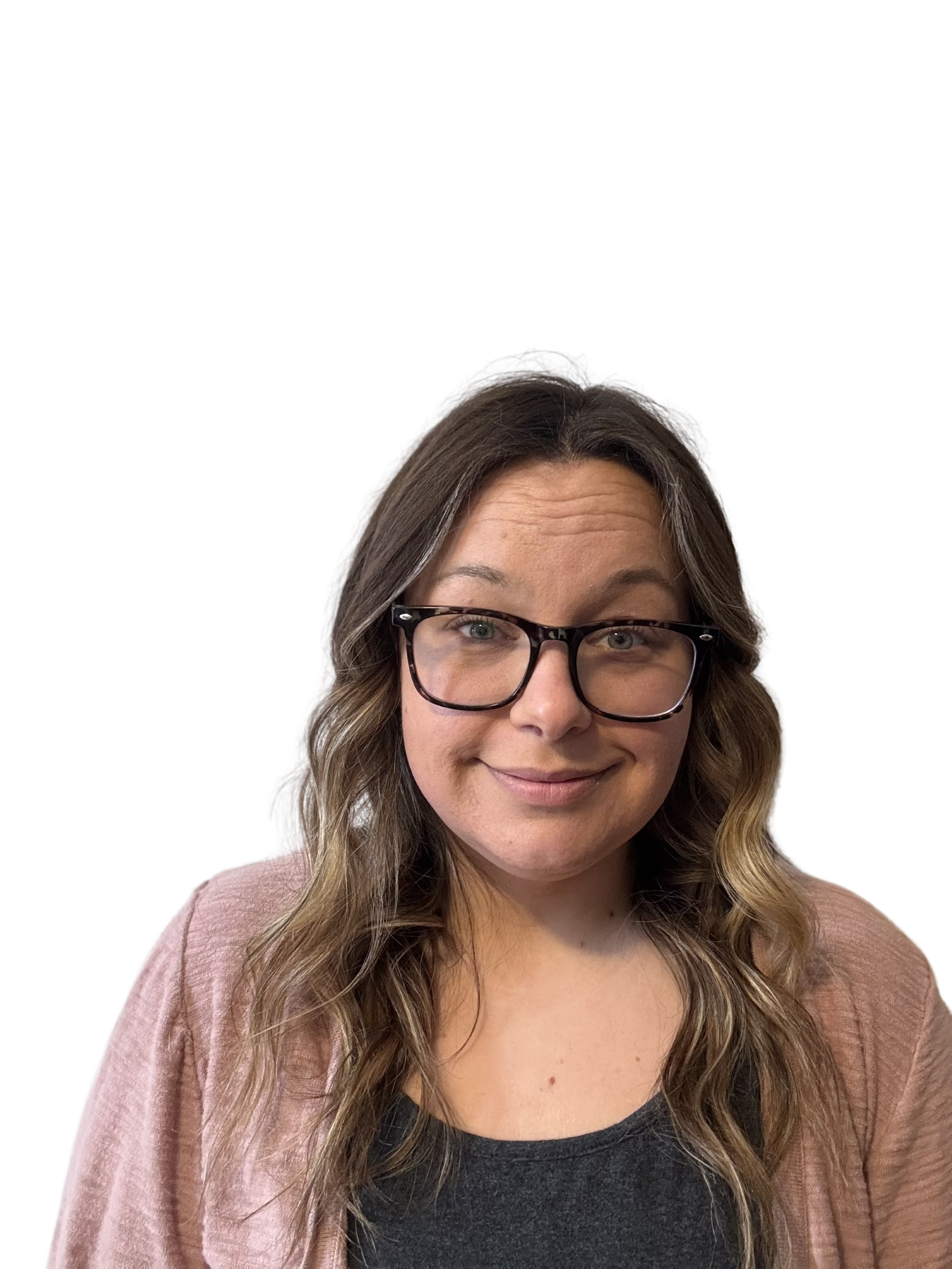 Woman wearing glasses and a pink cardigan smiles at the camera.