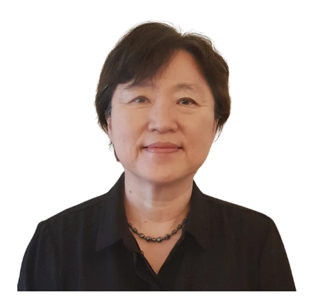 Woman with short dark hair wearing a black shirt and beaded necklace smiles at the camera.