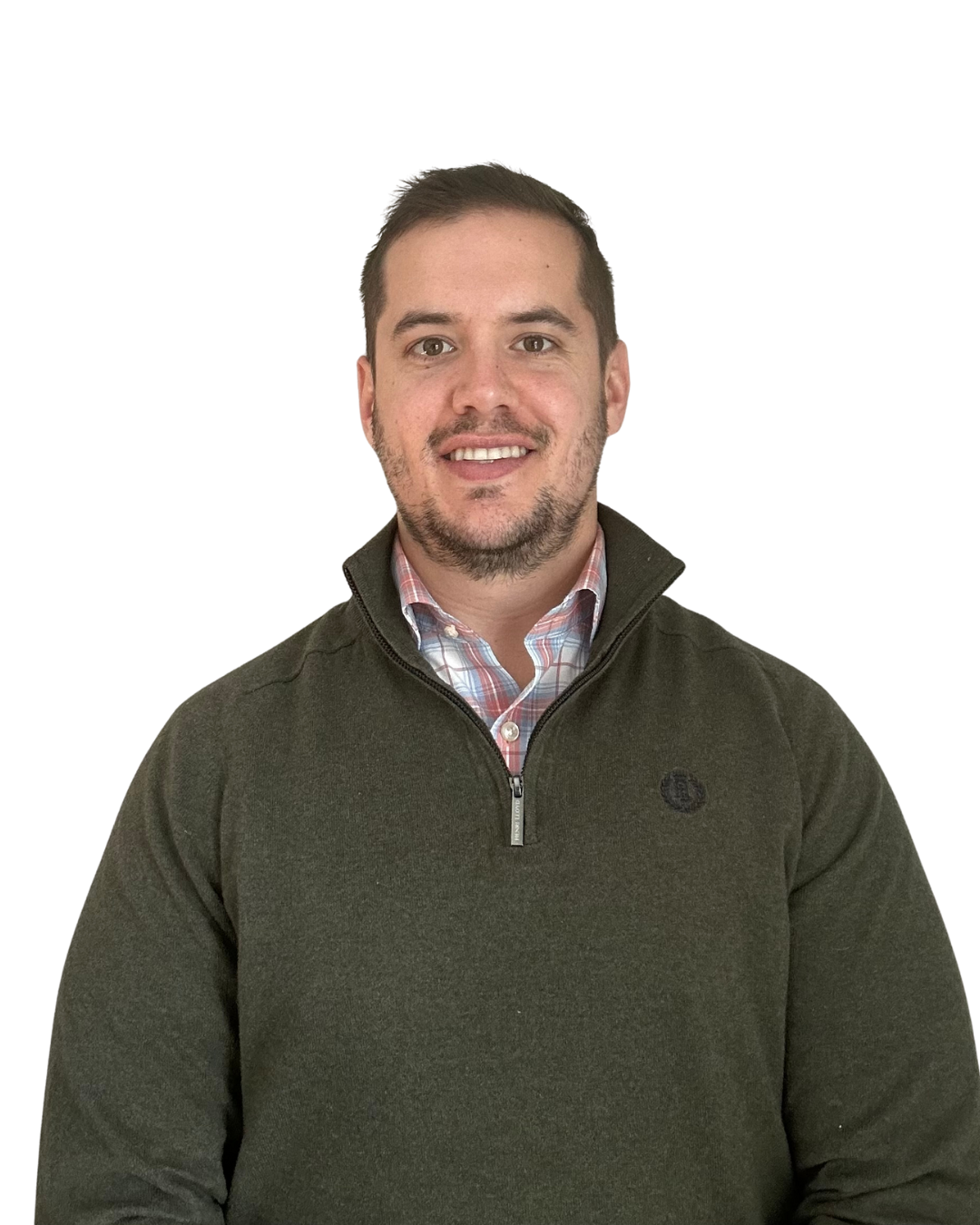 Man with a short haircut, wearing a green sweater and patterned shirt, smiling. White background.