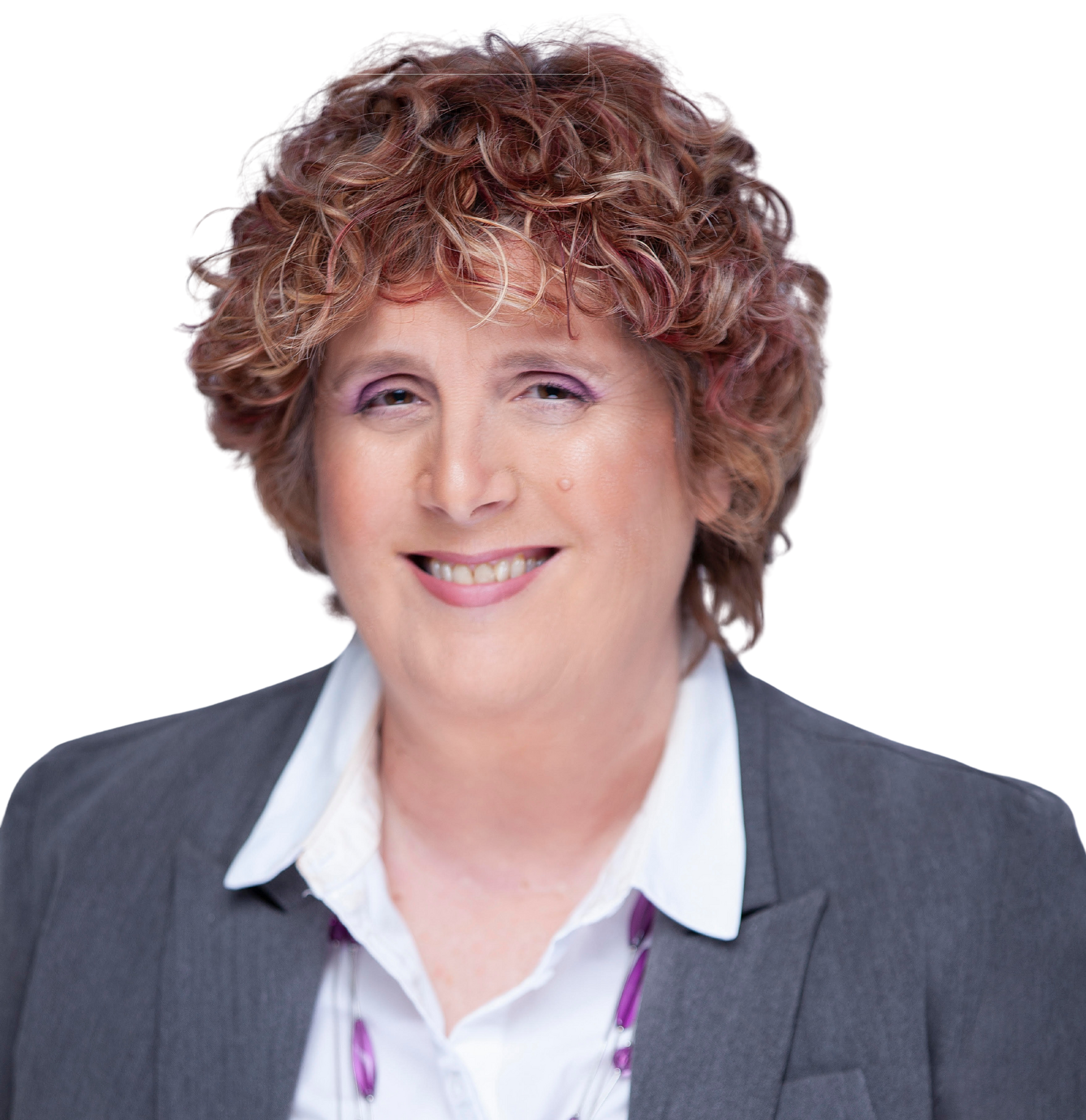 Woman in gray blazer smiling, wearing purple jewelry, against a light gray backdrop.