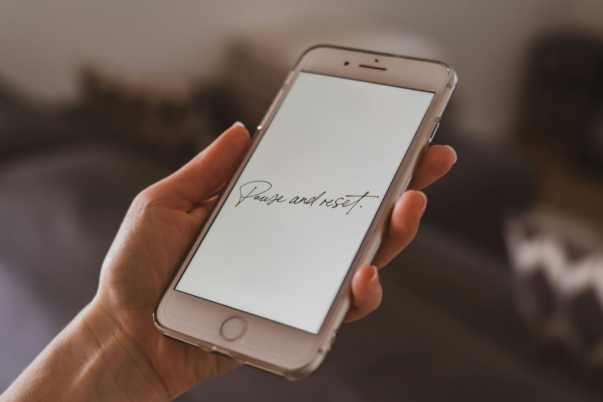 Hand holding a smartphone displaying 