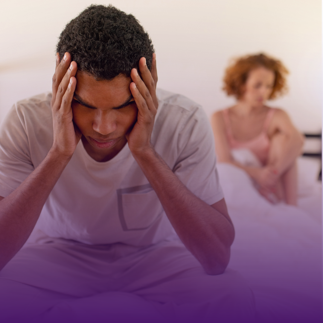 Man with head in hands, slumped on bed; woman in background, sitting. Purple gradient.