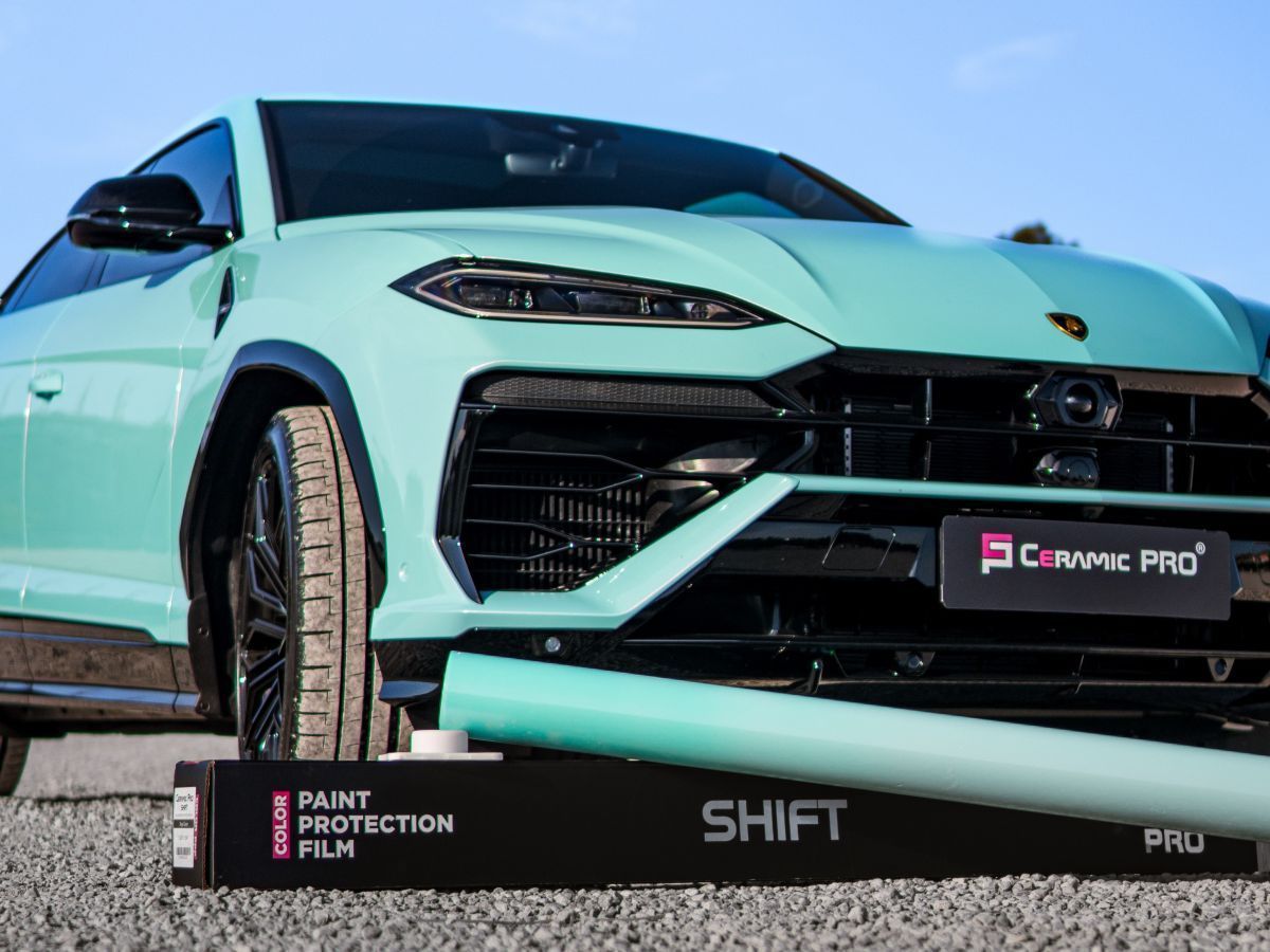 A black mercedes amg gt is parked in a garage.
