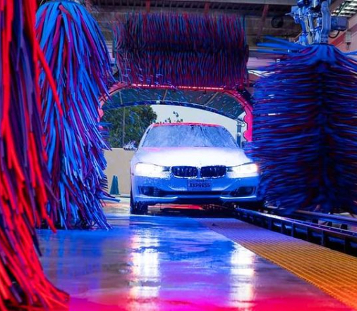 MR EXPRESS CAR WASH in texas. Tunnel car wash picture of car going through wraps.