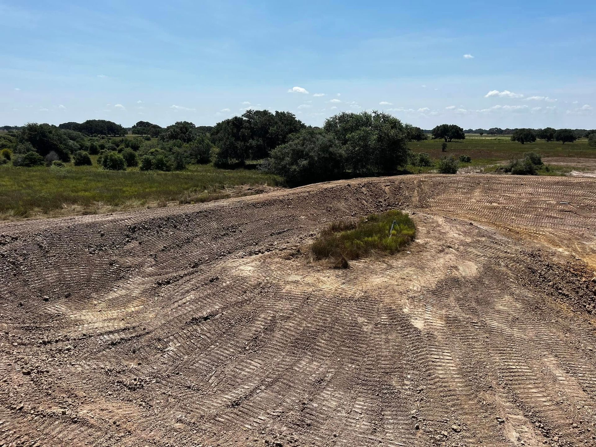 Finished pond with island for ranch and recreational land