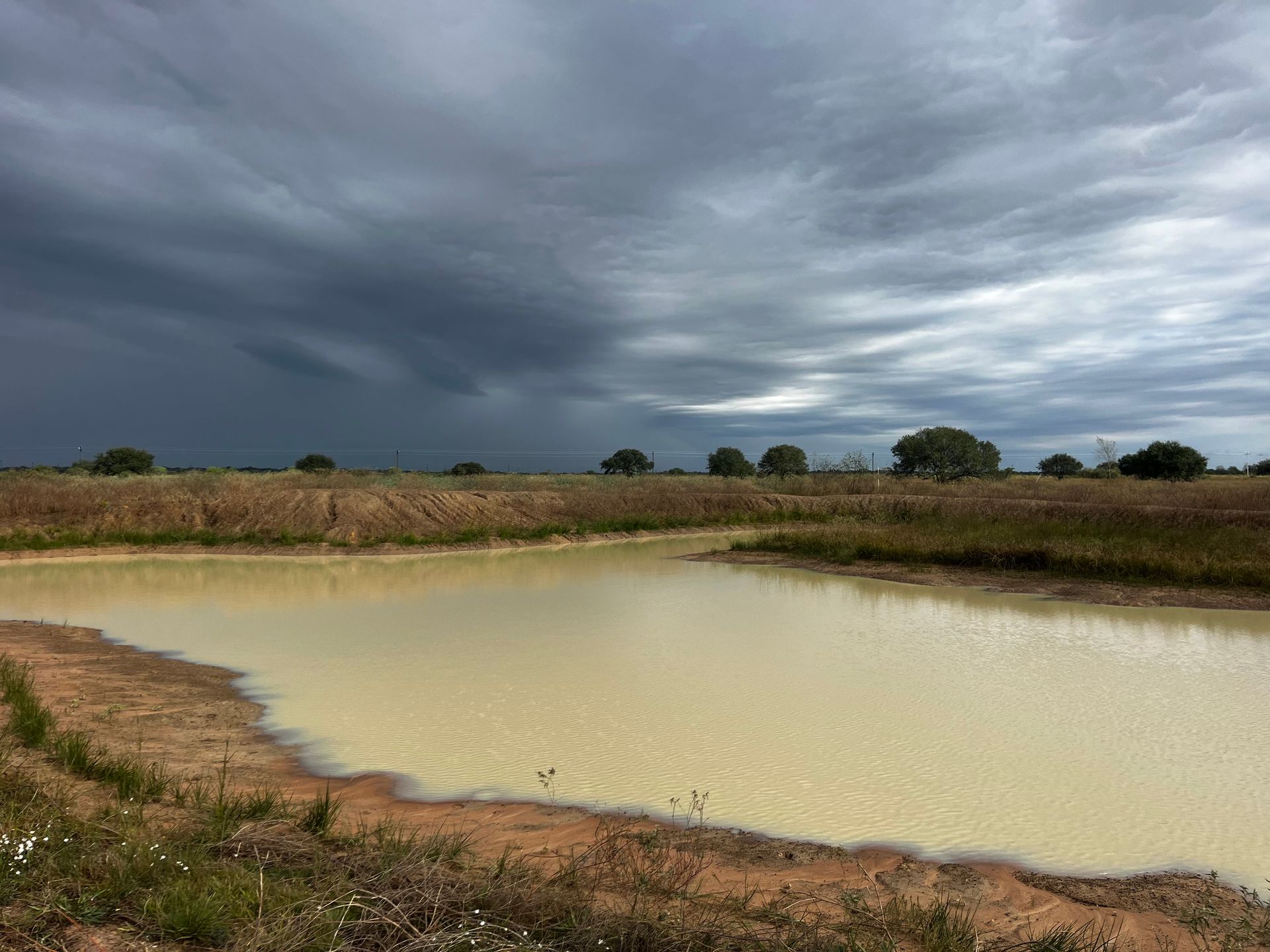 Finished pond with water for Texas acreage property