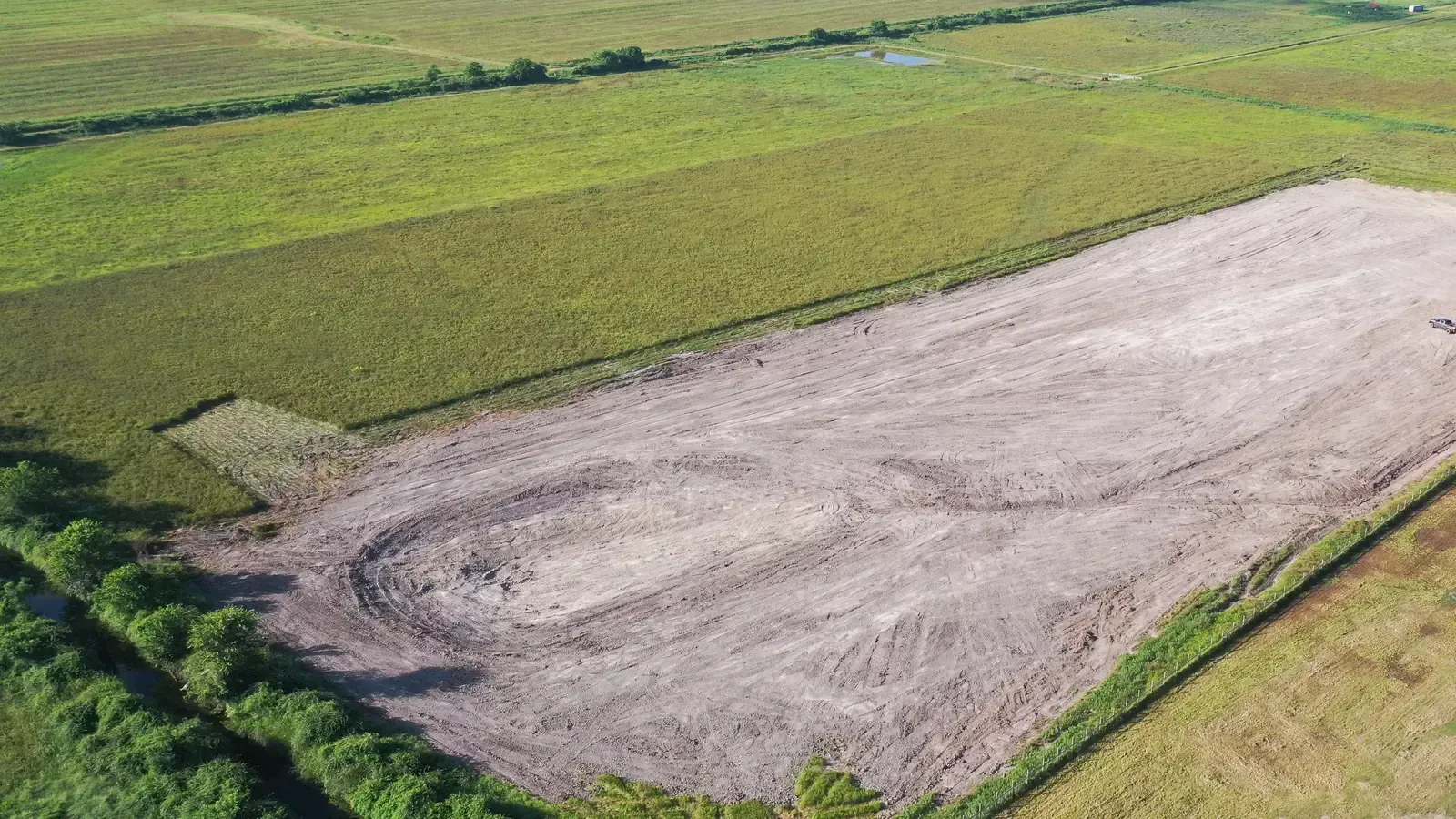 Aerial view of approximately eight acres of freshly graded former farmland in Cat Spring, Texas