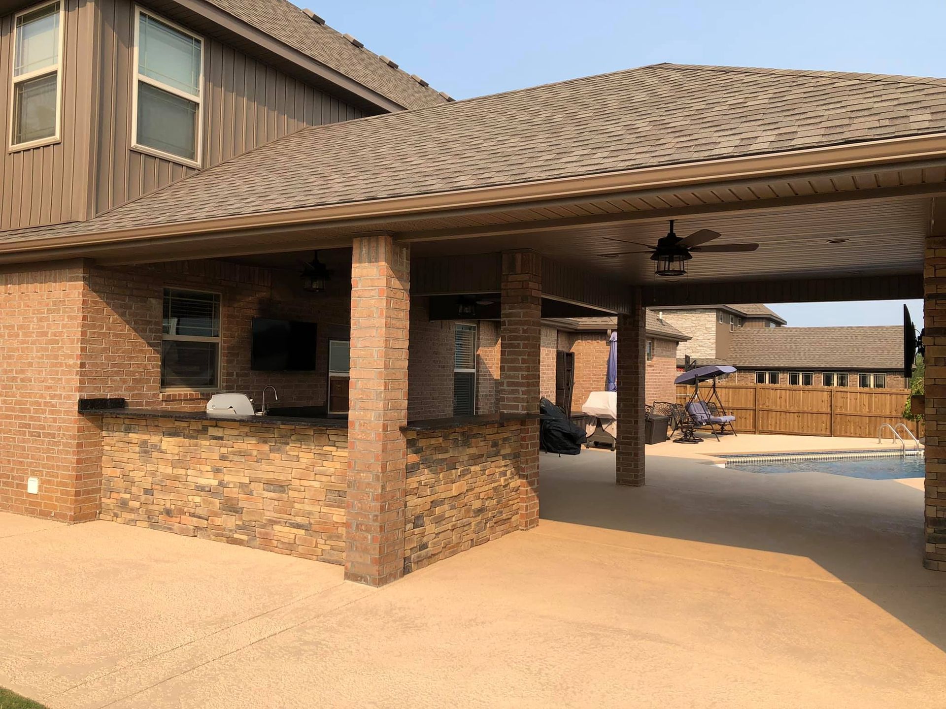 A house with a covered patio and a swimming pool