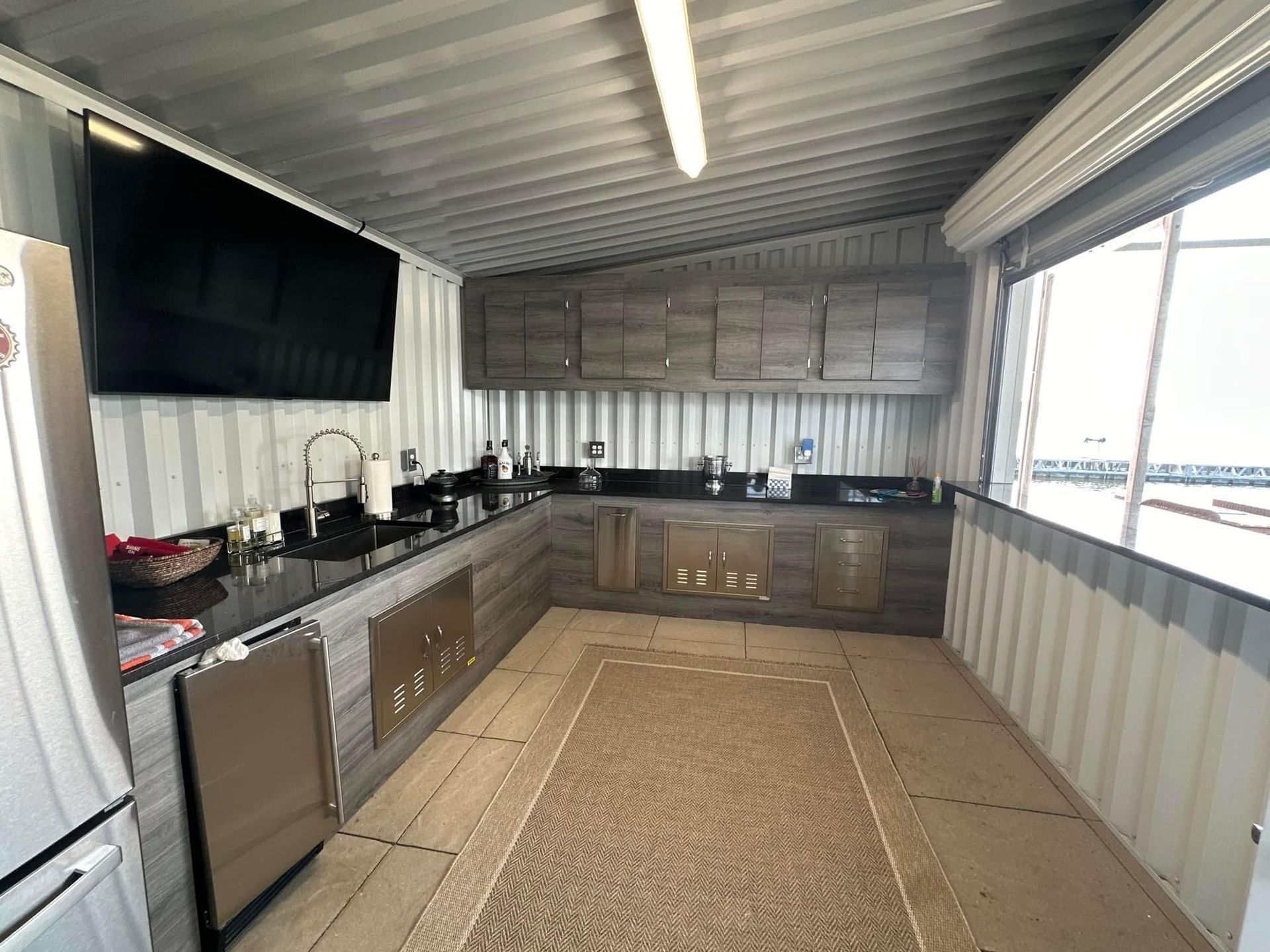 A kitchen with a large flat screen tv on the wall