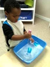 Kid Playing on Table — Woodridge, IL — Montessori of Woodridge
