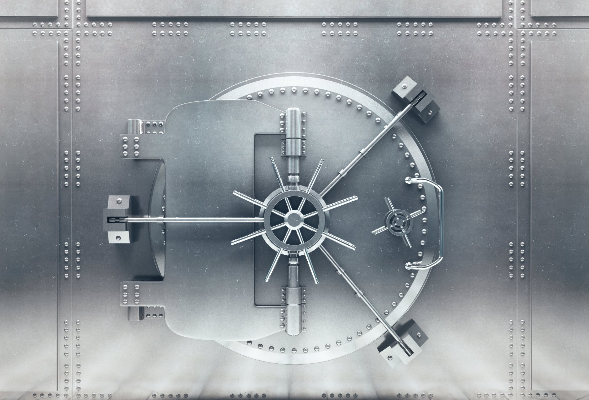 Close-up view of a large, steel bank vault door with a prominent locking mechanism.