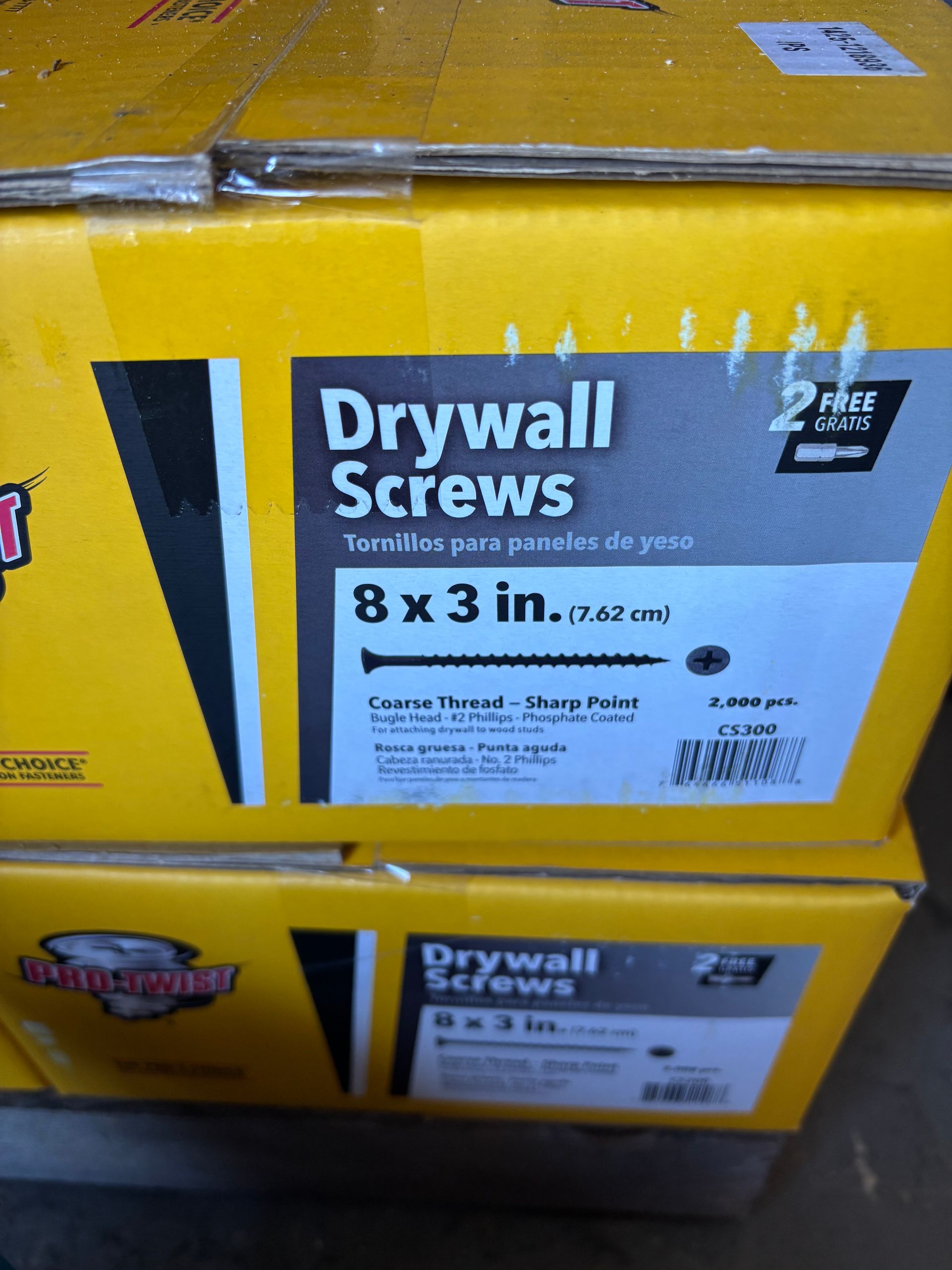 Boxes of drywall screws in yellow packaging, showing an 8 x 3 in. label.