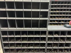 Shelves filled with small parts and bins in an industrial storage area